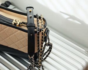 Chanel Handbag Sitting On Luggage