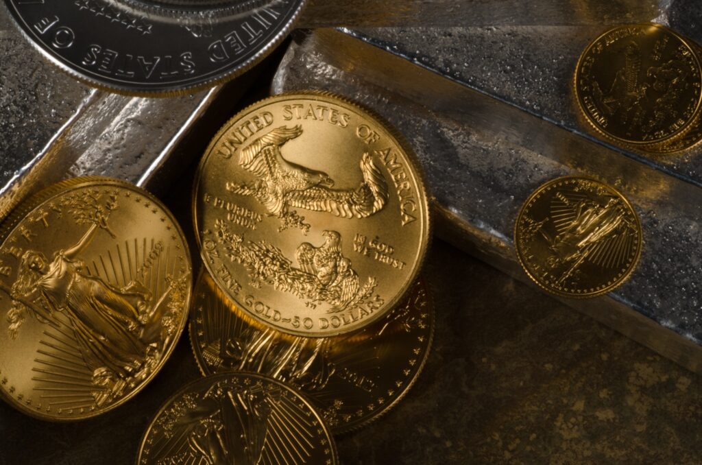 American gold coins arranged over silver bullion bars